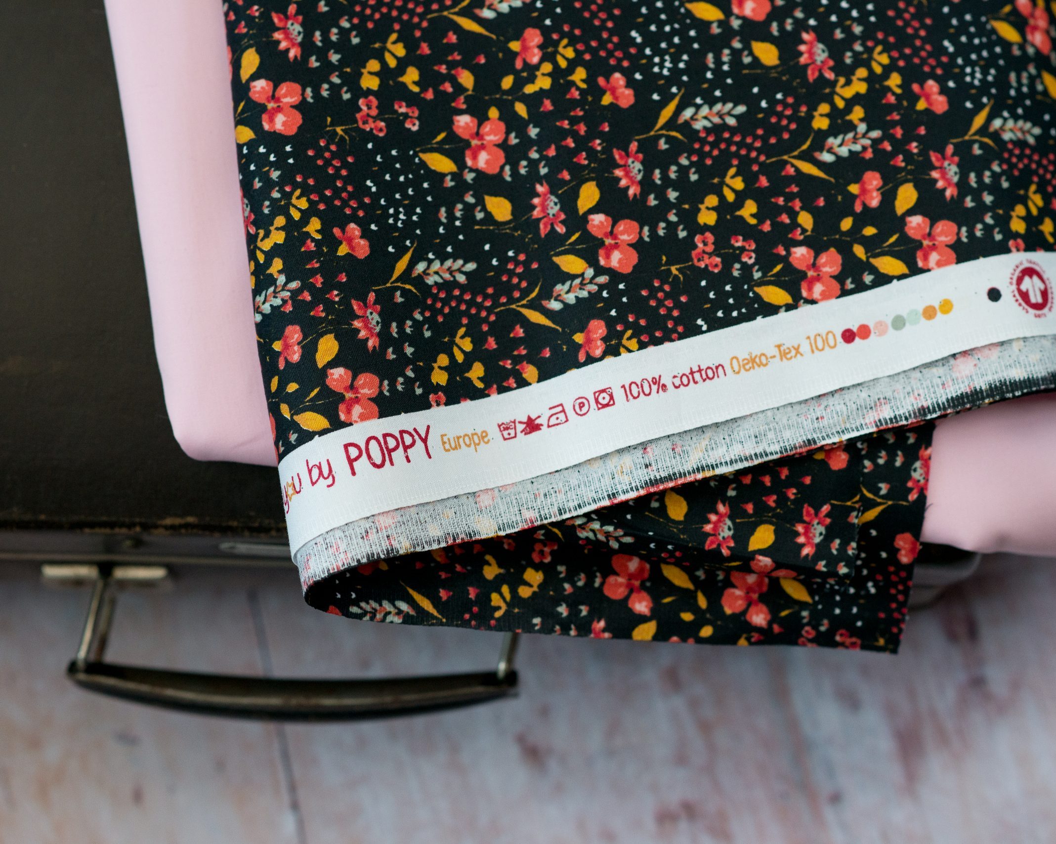 Black flower patterned organic cotton fabric used in sustainable lifestyle products for equilibrium lifestyle